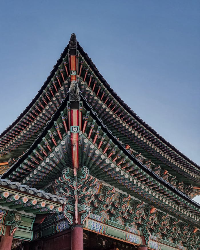 Detailed view of the ornate eaves of Gyeongbokgung Palace in Seoul, showcasing traditional Korean architecture.
